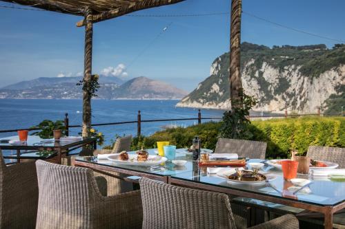 a restaurant with a view of the ocean at Villa Marina Capri in Capri