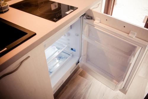 an empty refrigerator with its door open in a kitchen at Casa Bassetto in Longare