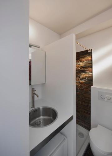 a bathroom with a sink and a toilet at Mini Loft ULB DELTA area with terrace in Brussels