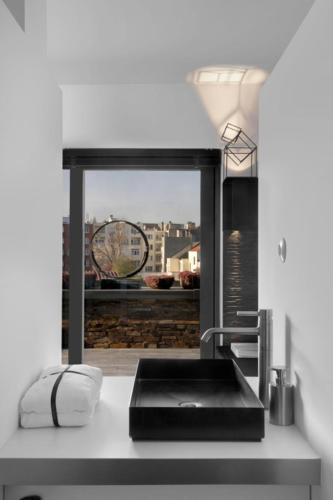 a kitchen with a sink and a window with a view at Mini Loft ULB DELTA area with terrace in Brussels