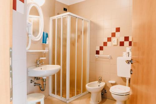 a bathroom with a toilet and a sink at Hotel Villa Claudia in Bellaria-Igea Marina