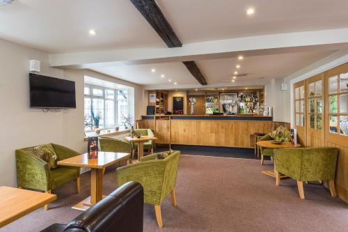 a waiting room with tables and chairs and a bar at The Limes Country Lodge Hotel & Admiral Restaurant in Solihull