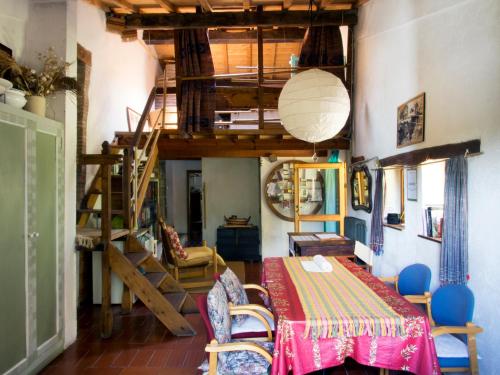 a living room with a table and a loft at Casa La Valle, Gubbio, Frazione Santa Cristina in Gubbio