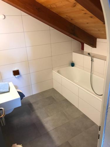 a bathroom with a tub and a sink at Hotel Restaurant Kulm in Triesenberg