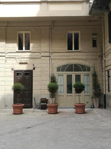 a building with potted plants sitting outside of it at C'era una "volta"... un appartamento a Torino in Turin