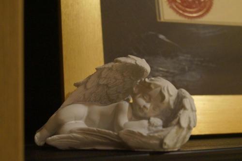 a statue of an angel laying on a table at Bed and Brekfast Donatella in Piran