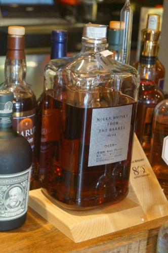 a bottle of whiskey sitting on a wooden cutting board at Bed and Brekfast Donatella in Piran