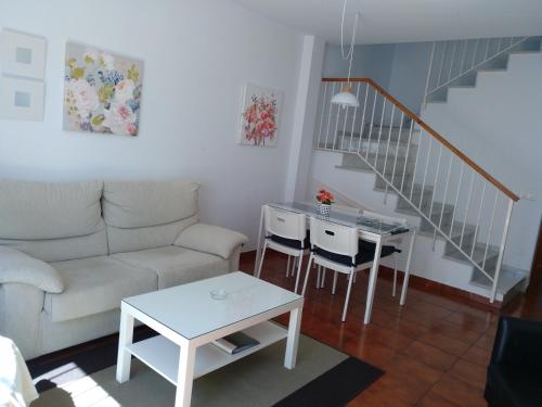 a living room with a couch and a table at Apartamentos Luna de Nerja in Nerja