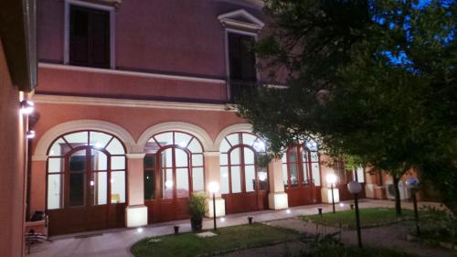 a building with windows and lights in front of it at Oasi Ottocento in Quartu SantʼElena