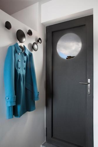 a door with a coat on a wall with a window at Mini Loft ULB DELTA area with terrace in Brussels
