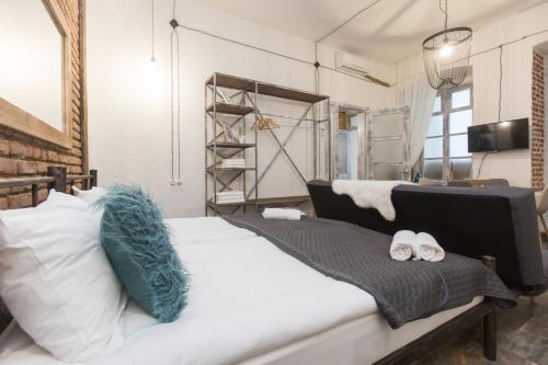a bedroom with a bed with two shoes on it at New&Old in Tbilisi City