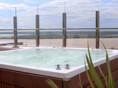 a jacuzzi tub with a view of the water at Dazzler by Wyndham Rosario in Rosario