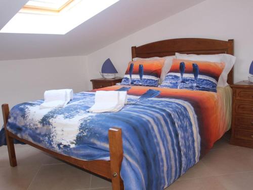 a bedroom with a large bed with a blue comforter at Europa Beach House in Manta Rota