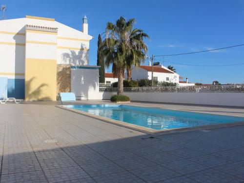 a swimming pool in front of a house at Europa Beach House in Manta Rota