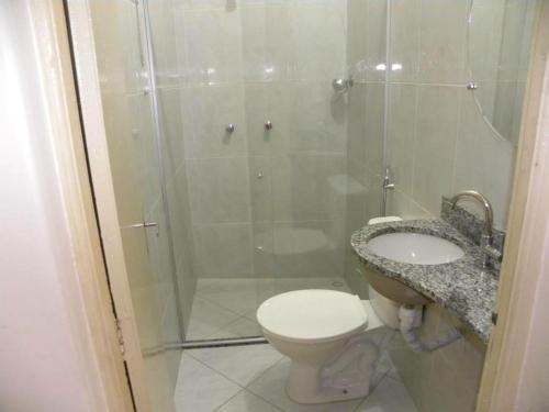 a bathroom with a shower and a toilet and a sink at Hotel Meirelles in Montanha