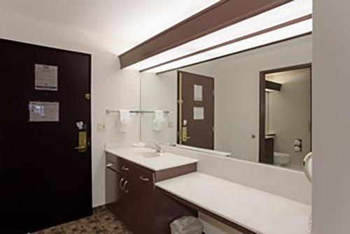 a bathroom with a sink and a large mirror at Shilo Inn Portland Airport in Portland