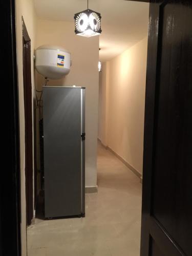 a hallway with a refrigerator and a water tank at Chalet in Belagio Ain Sokhna in Ain Sokhna