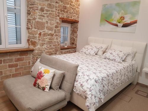 a bedroom with a bed and a couch at Studio Apartment B&B Zadar Sunset in Zadar