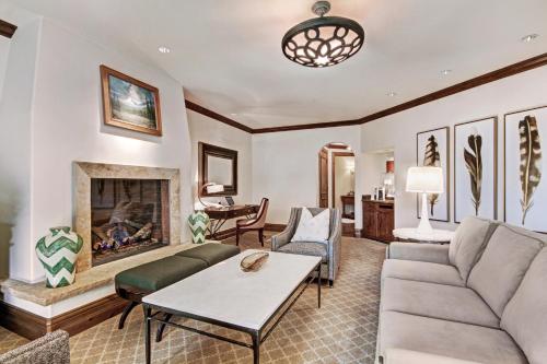 a living room with a couch and a fireplace at The Arrabelle at Vail Square, a RockResort in Vail