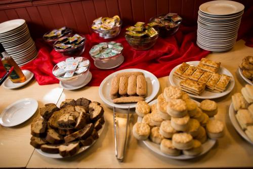 a table full of different types of pastries and desserts at Casablanca Hotel & Spa in Santa Rosa de Calamuchita