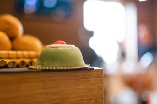 a green hat sitting on top of a table at Hotel Porta Reale in Noto