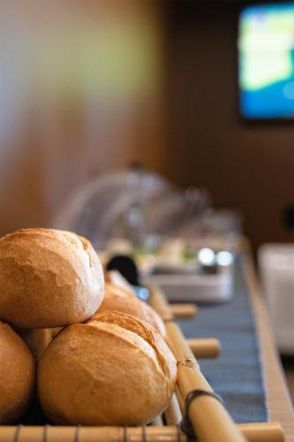 a group of loaves of bread sitting on a table at Hotel Porta Reale in Noto