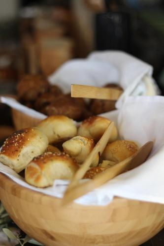 a wooden bowl filled with buns and chop sticks at Boutique Hotel Valsabbion in Pula