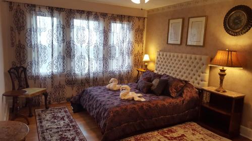 a bedroom with a bed with two swans on it at Natalie House in Boston