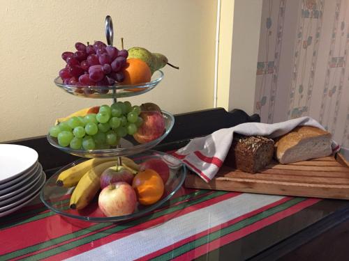 two bowls of fruit on top of a table at Borgs Villahotell och B&B in Norrköping