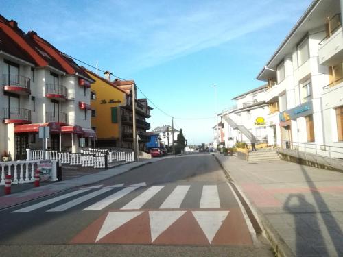 an empty street with a crosswalk in a city at Hotel Candano in Isla