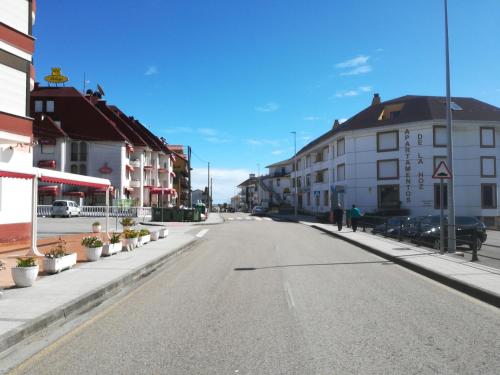 an empty street in a town with buildings at Hotel Candano in Isla