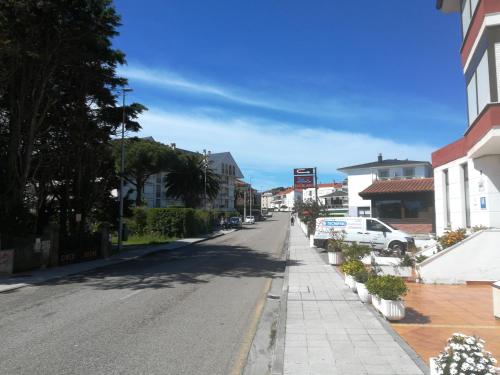 an empty street in a small town with buildings at Hotel Candano in Isla