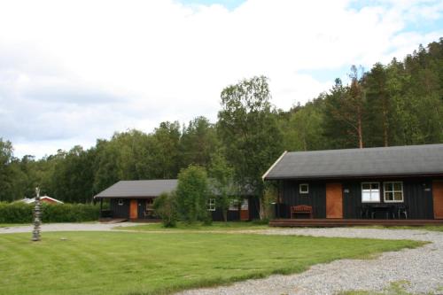 a log cabin with a yard and a house at Gargia Lodge in Alta