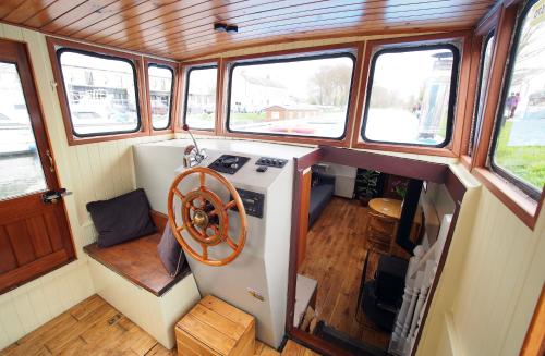 an interior view of a kitchen in a boat at Roisin Dubh Houseboat in Sallins