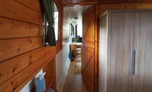a hallway in a house with wooden walls and a door at Roisin Dubh Houseboat in Sallins