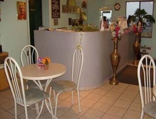 a table and chairs in a restaurant with a counter at Express Inn Thomson in Thomson