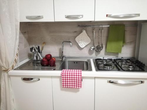 a kitchen with a sink and a stove at Casa del Corso in Taviano