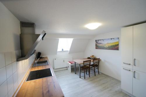 a kitchen with a table and a dining room at Apartment Kirschblüte in Appenweier