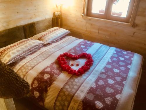 a bedroom with a bed with a heart on it at Il Roccolino in Valsecca