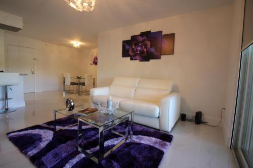 a living room with a white couch and a glass table at Yacht Club at Aventura 1 Bd 1 Bth Brand New in Aventura