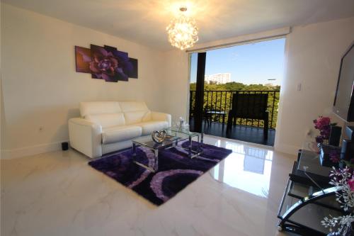 a living room with a white couch and a glass table at Yacht Club at Aventura 1 Bd 1 Bth Brand New in Aventura
