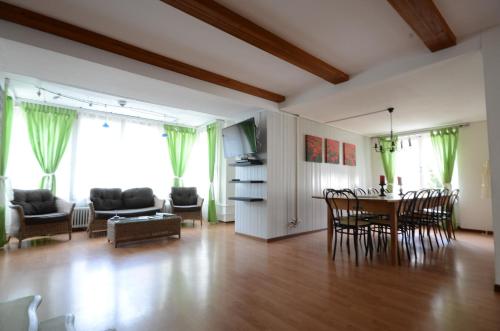a living room with a table and chairs at Interlaken Town House Sleeps 12 guests Central in Interlaken