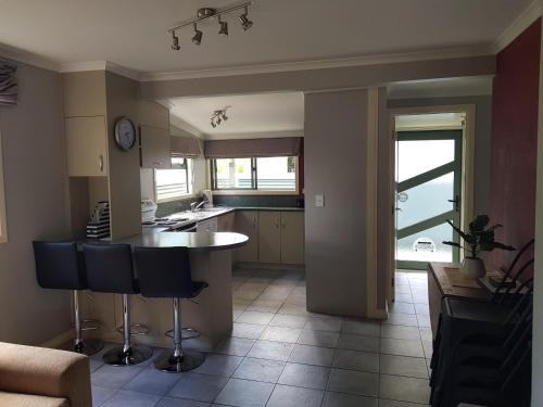 a kitchen with a table and chairs in a room at Central Taupo Townhouse in Taupo