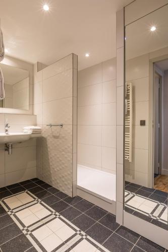 une salle de bain avec douche et lavabo dans l'établissement CADET Residence, à Paris