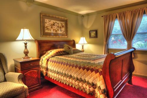 a bedroom with a bed and a chair at Los Gatos Bed & Breakfast in Penn Yan