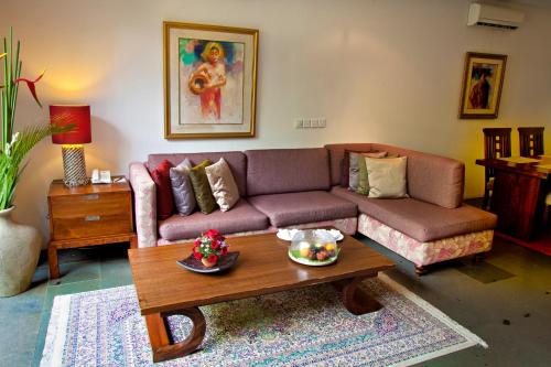 a living room with a couch and a coffee table at Gending Kedis Luxury Villas & Spa Estate in Jimbaran