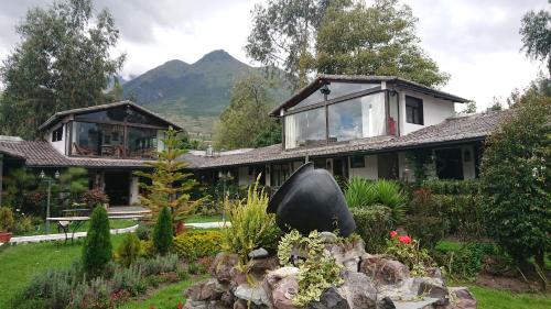 a house with a garden in front of it at Villa Mimi in Otavalo