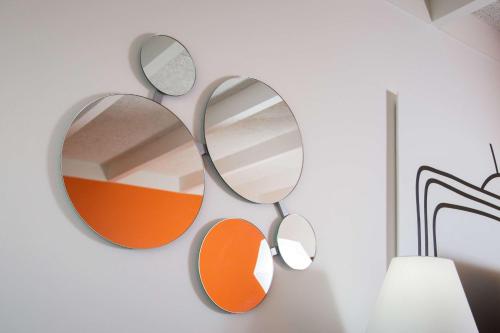 a pair of mirrors hanging on a wall at Howard Johnson by Wyndham Toms River in Toms River