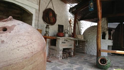 a room with a stone fireplace in a house at Villa Mimi in Otavalo