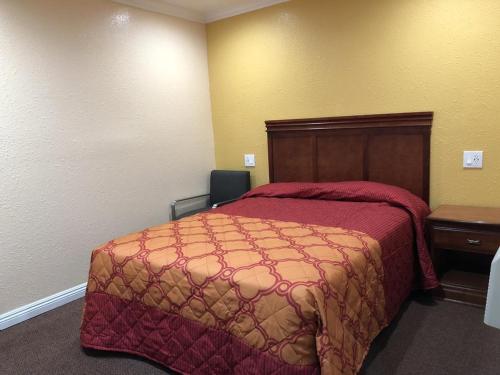 a hotel room with a bed and a desk at Hotel West Inn, Hollywood - LA in Los Angeles